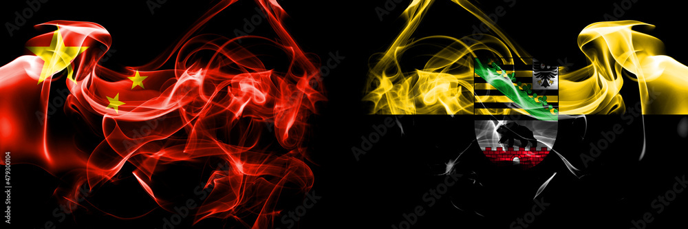 Flags of China, Chinese vs Saxony Anhalt, state. Smoke flag placed side by side on black background. Flags of China, Chinese vs Saxony Anhalt, state. Smoke flag placed side by side on black background.