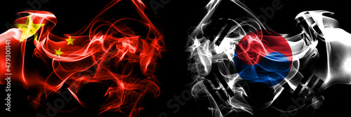 Flags of China, Chinese vs South Korea, Korean. Smoke flag placed side by side on black background.