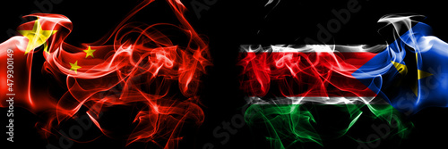 Flags of China, Chinese vs South Sudan. Smoke flag placed side by side on black background.