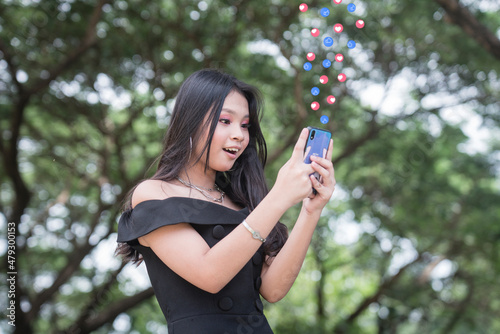 An amazed woman checks her cellphone, surprised that her crush left her a message. photo