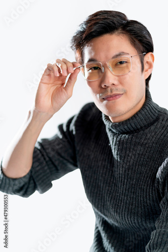 smart glasses asian male thinking action pose,attractive casual cloth adult asian male wear sweater and glasses studio shot hand touch glasses with think and concentrate smile with confident