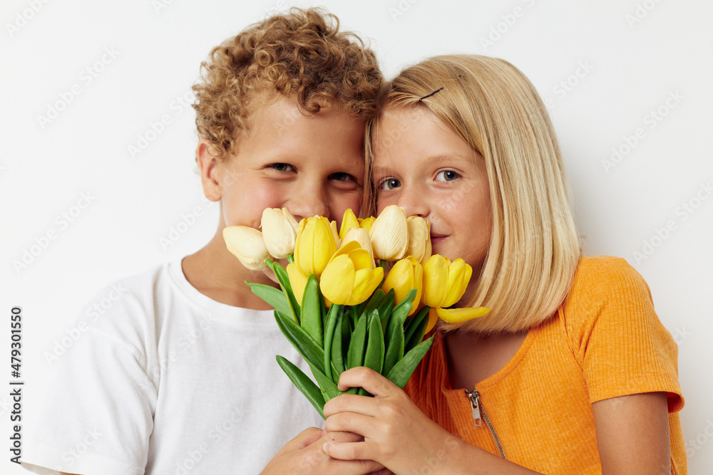 Cute preschool kids holiday friendship with a gift Yellow flowers lifestyle unaltered Cute preschool kids holiday friendship with a gift Yellow flowers lifestyle unaltered