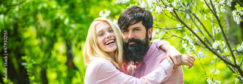 Spring couple in love, banner. Romantic couple in love feeling happiness. Young lovely couple walking in spring park. photo