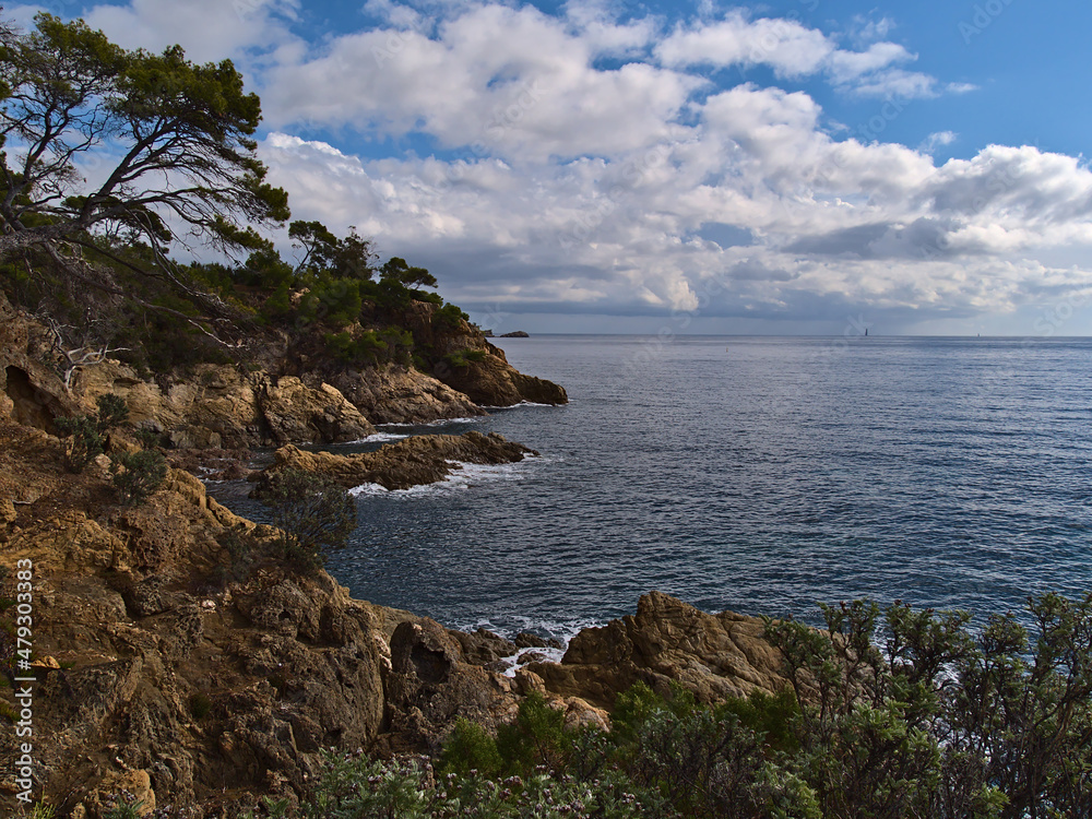 Beautiful view of the mediterranean coast with rugged rocks near town La Lavandou at the French Riviera, France at Pointe du Layet on cloudy day.