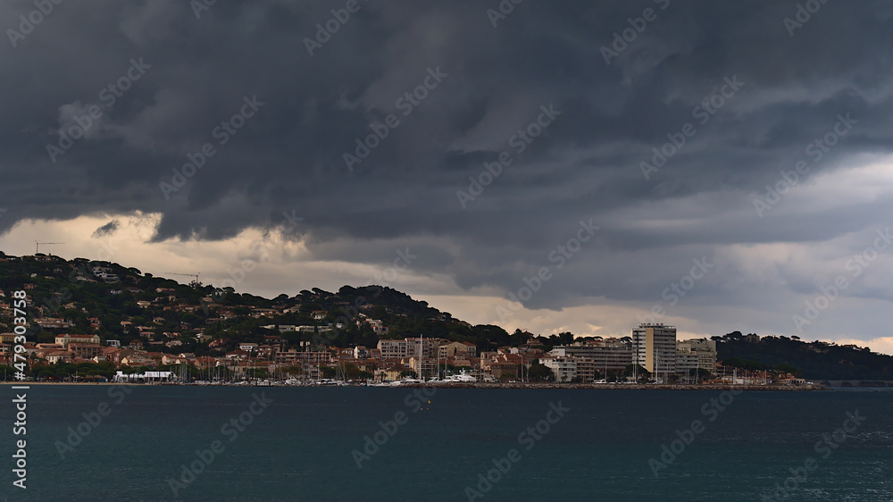 Beautiful view of town Sainte-Maxime, a popular holiday destination at the French Riviera, on stormy day in autumn season with thuderstorm clouds.