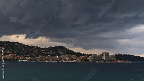 Beautiful view of town Sainte-Maxime, a popular holiday destination at the French Riviera, on stormy day in autumn season with thuderstorm clouds.