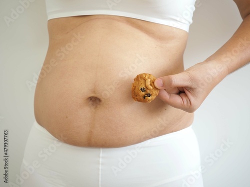 Cellulite, excess fat on at abdomen of woman. food concept. closeup photo, blurred. photo