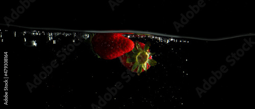 Colorful freshness fruit falling in to water splash and black background