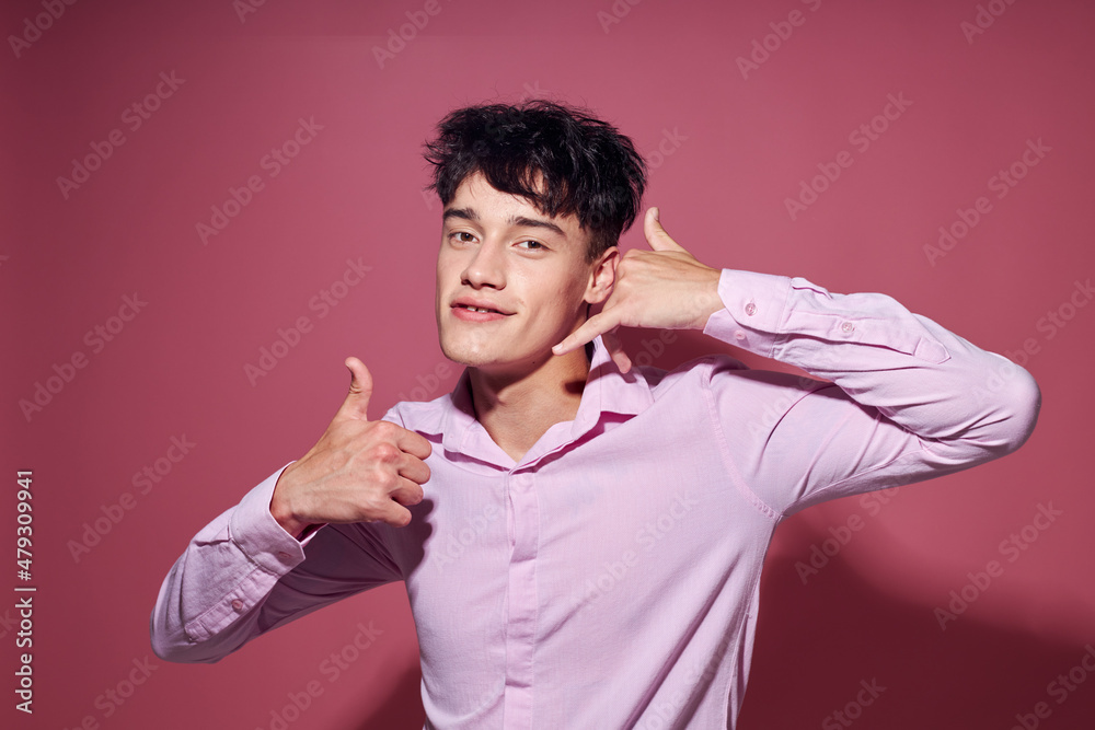 Photo of romantic young boyfriend in a pink shirt gesturing with his hands Lifestyle unaltered Photo of romantic young boyfriend in a pink shirt gesturing with his hands Lifestyle unaltered