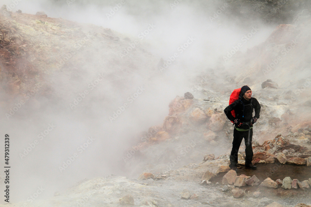 Hiker in Iceland in clouds of volcanic smoke Hiker in Iceland in clouds of volcanic smoke