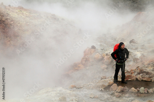 Hiker in Iceland in clouds of volcanic smoke