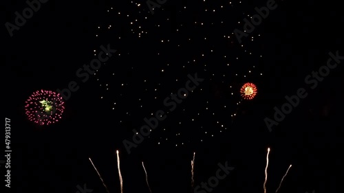 4K. loop seamless of real fireworks background. abstract blur of real golden shining fireworks with bokeh lights in the night sky. glowing fireworks show. New year's eve fireworks celebration