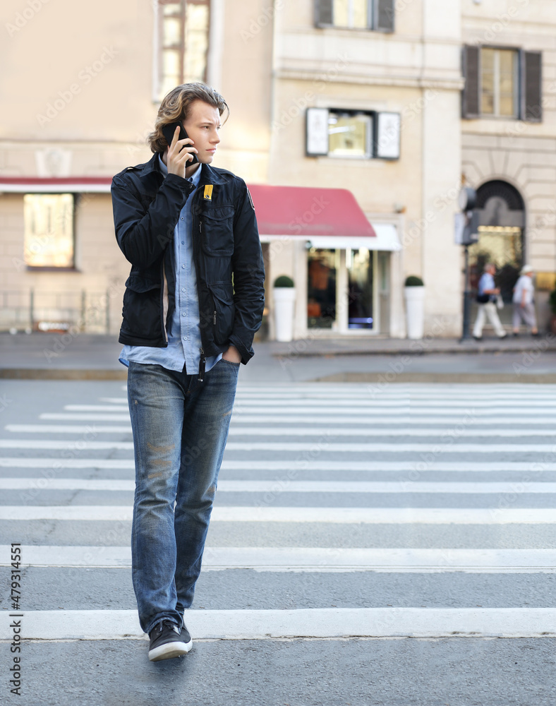 Lifestyle portrait of a teenage boy using a smart phone outdoors Lifestyle portrait of a teenage boy using a smart phone outdoors