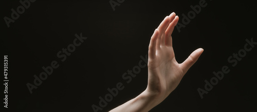 Praying hands to God in the dark. Woman hands reaching out to God or for help in barokko style photo