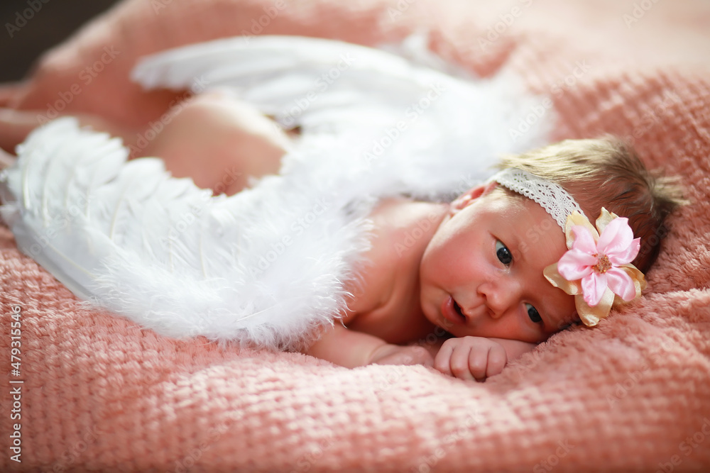 A newborn baby lies in her mother's arms. A beautiful baby of European appearance is sleeping. A newborn baby lies in her mother's arms. A beautiful baby of European appearance is sleeping.