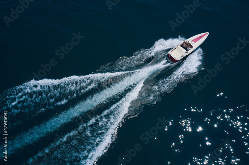 Wallpaper Mural White boat on the water top view. White boat with people on blue water in the rays of the sun aerial view. Boat in motion top view. Torontodigital.ca