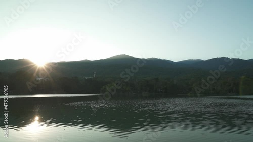 Sunset behind mountain landscape at Angkaew reservoir at Chiangmai university, my evening lake view makes me free photo