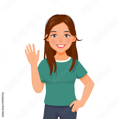 happy young woman with hand on her waist, smiling, waving hand cheerfully saying hi, hello nice to meet you, welcoming people with informal greeting gesture