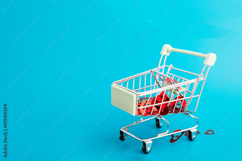 Valentine's Day-romance, love, lots of hearts in a shopping cart trolley from the supermarket on a blue background with copy space