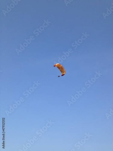 Wallpaper Mural A MINIMAL PHOTO OF A PARAGLIDER PARAGLIDING IN THE BLUE SKY Torontodigital.ca