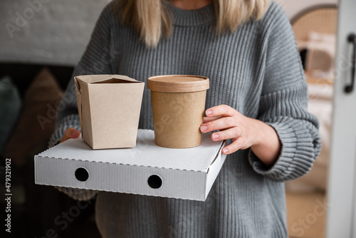 Zero waste lunch boxes, food delivery box with pizza in the girl's hands. Lunch to order at home