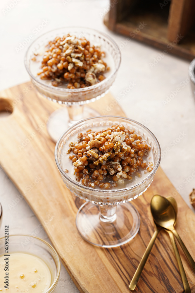 Traditional east european (ukrainian, polish, belarusian) religious christmas dish kutia made of wheat, poppy seeds, honey, walnuts and dried berries. modern style in champagne glasses Traditional east european (ukrainian, polish, belarusian) religious christmas dish kutia made of wheat, poppy seeds, honey, walnuts and dried berries. modern style in champagne glasses