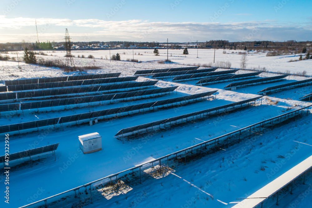 Aerial of solar panels covered with snow. Low efficiency during winter time in northern hemisphere. 