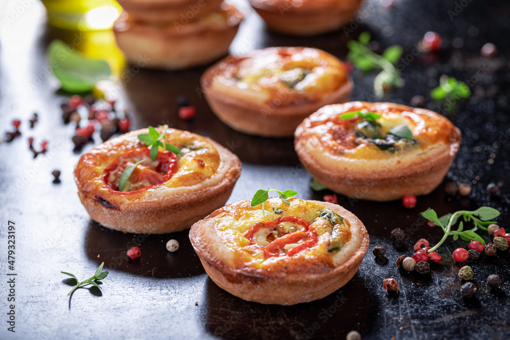 Tasty mini tart with cheese and tomatoes. Vegetarian party food.