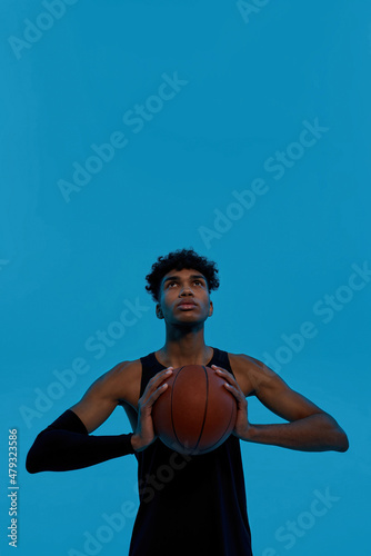 Basketball player hold basketball ball and look up