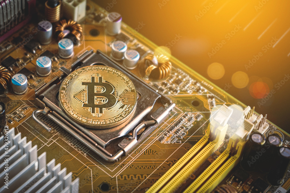 Golden bitcoin coin on computer motherboard, Bitcoin mining concept
