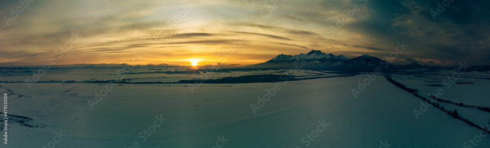 Winter mountain landscape at sunset. Sun and peaks in High Tatra Mountains