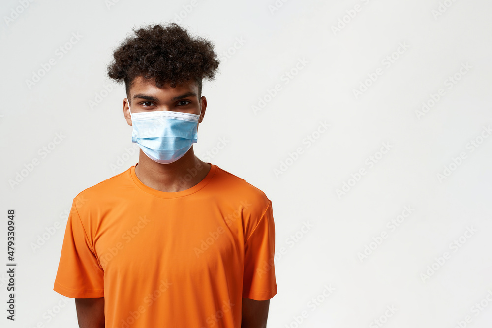 African man in medical mask looking at camera