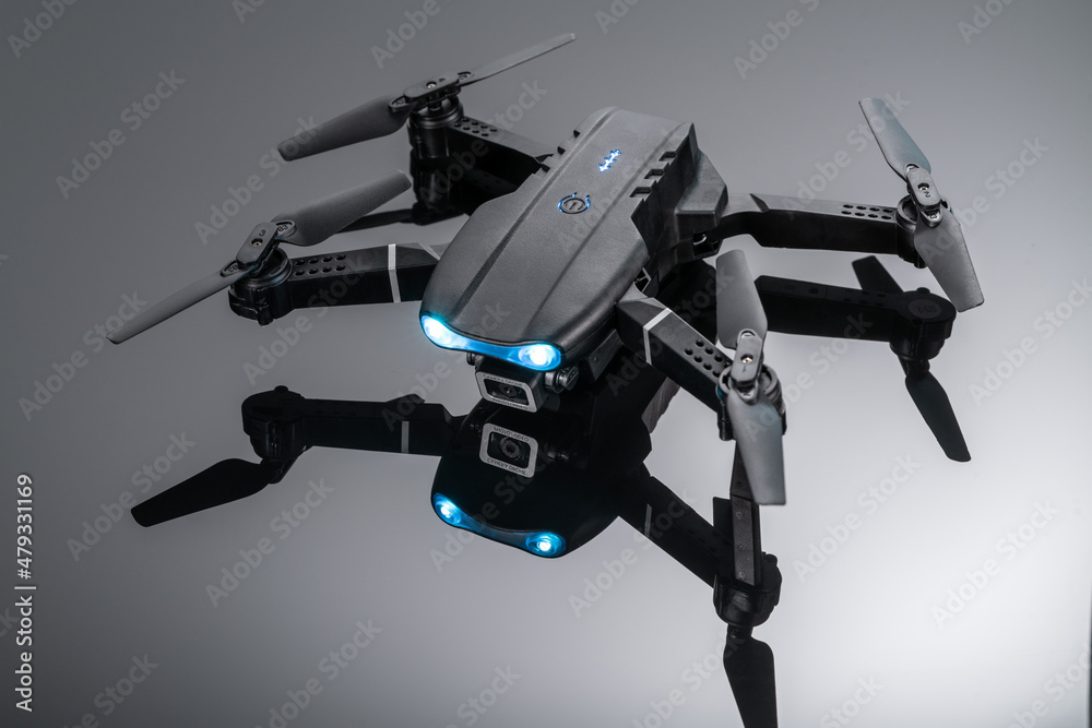 drone quadcopter with digital camera and sensors on black background. a black quadcopter with a camera on a black background. drone quadcopter with digital camera and sensors on black background. a black quadcopter with a camera on a black background.