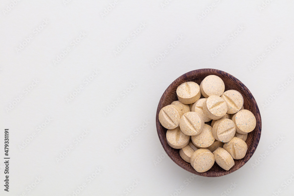 Alternative medicine tablets on a wooden spoon. Alternative medicine tablets on a wooden spoon.