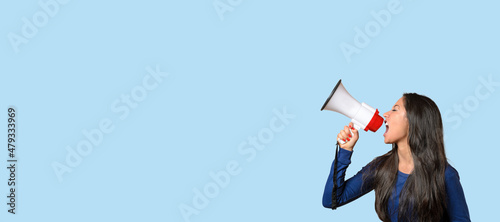 Young woman yelling over a loud hailer