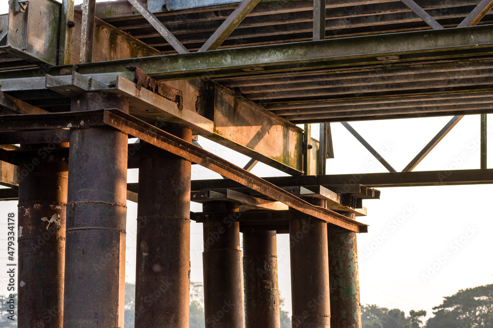 Aged rustic broken iron bridge structure close up view