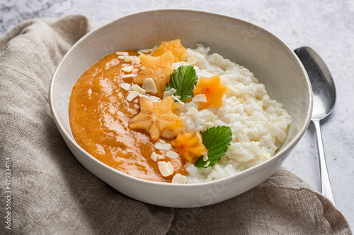 rice porridge with cinnamon scandinavian style. Rice porridge with persimmon puree. risengrod, scandinavian-style, rice porridge