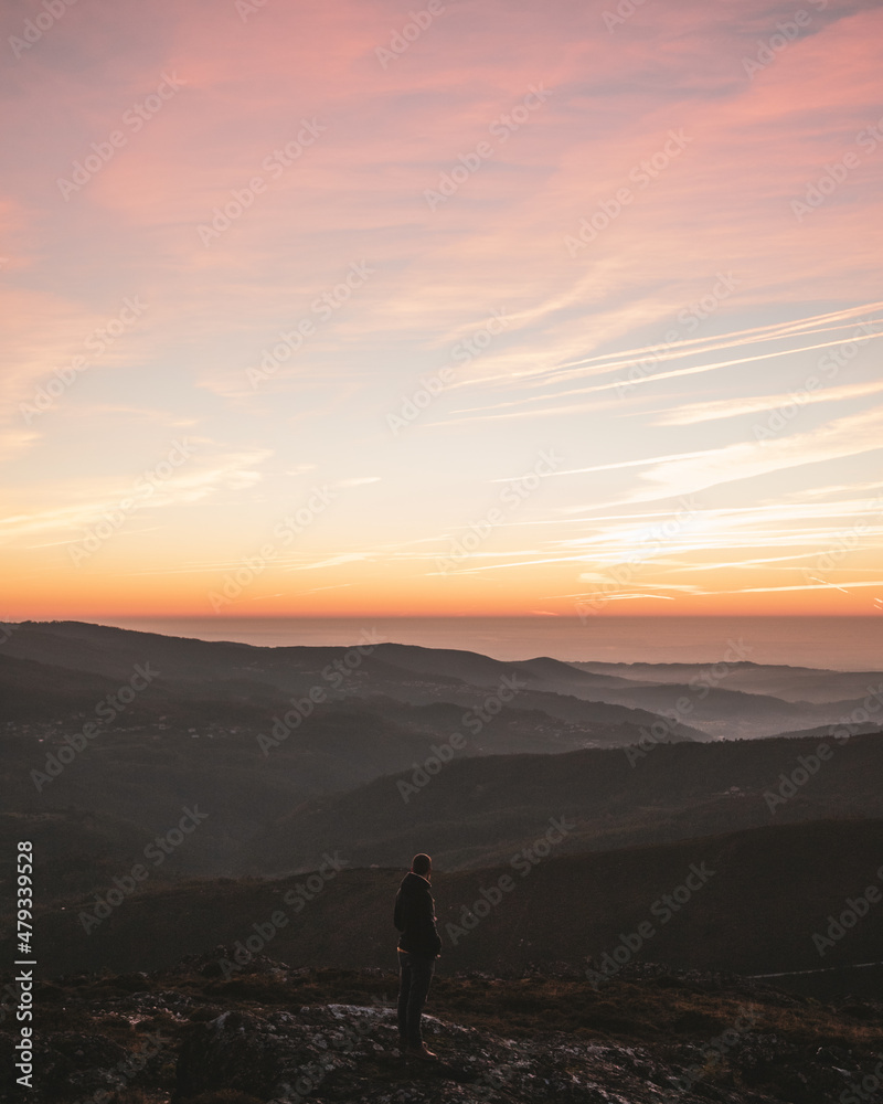 One man watching a colorful sunset in Serra da Freita Mountains