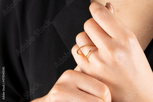 Close portrait of female model in gold and silver rings. Isolated on white background . Diamond jewelry. Diamond ring in women's hands