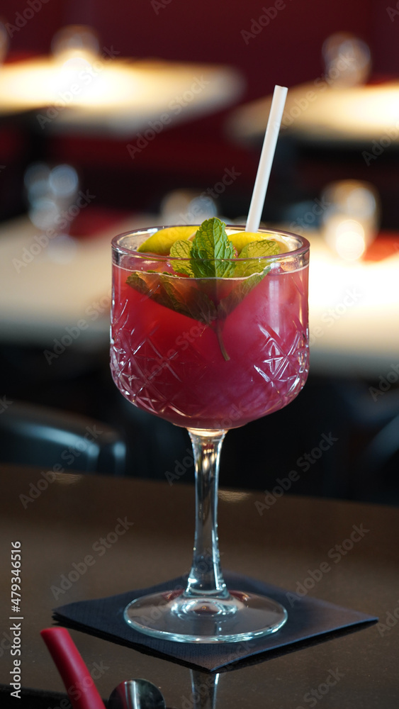 Alcoholic cocktails in a dark-lid bar environment from Berlin, Germany.