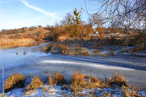 First frosts. The river starts to ice. Winter river. Rural landscape. Cold mountain river.