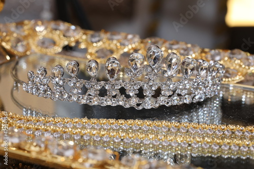 diamond-studded tiara or crown in a reflective tray