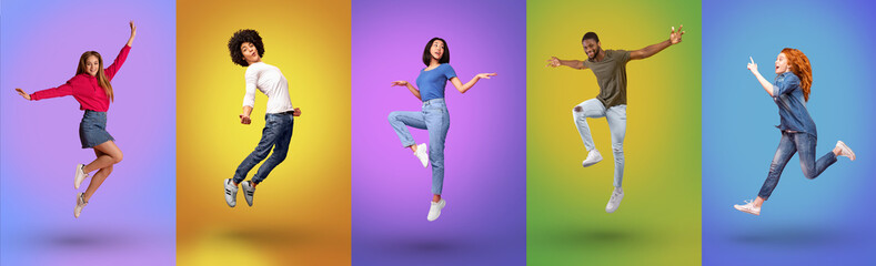 Full length of millennial international people jumping together, smiling at camera over bright neon studio backgrounds