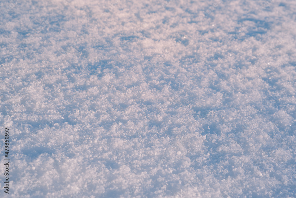 Snow surface texture in light blue tone. Winter season background.