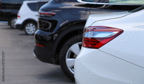 Closeup of rear, back side of white car parking in outdoor parking area. © Amphon