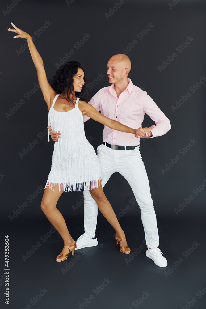 Dancing in the studio. Cheerful couple is together indoors Dancing in the studio. Cheerful couple is together indoors