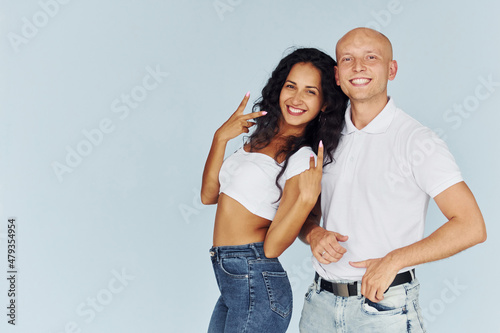 Smiling and posing for the camera. Cheerful couple is together indoors