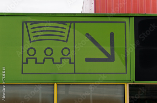 Movie theater sign with direction arrow on green background