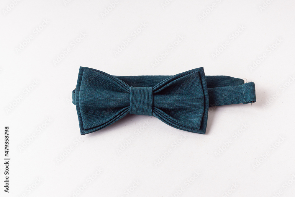 Green bow tie on light background