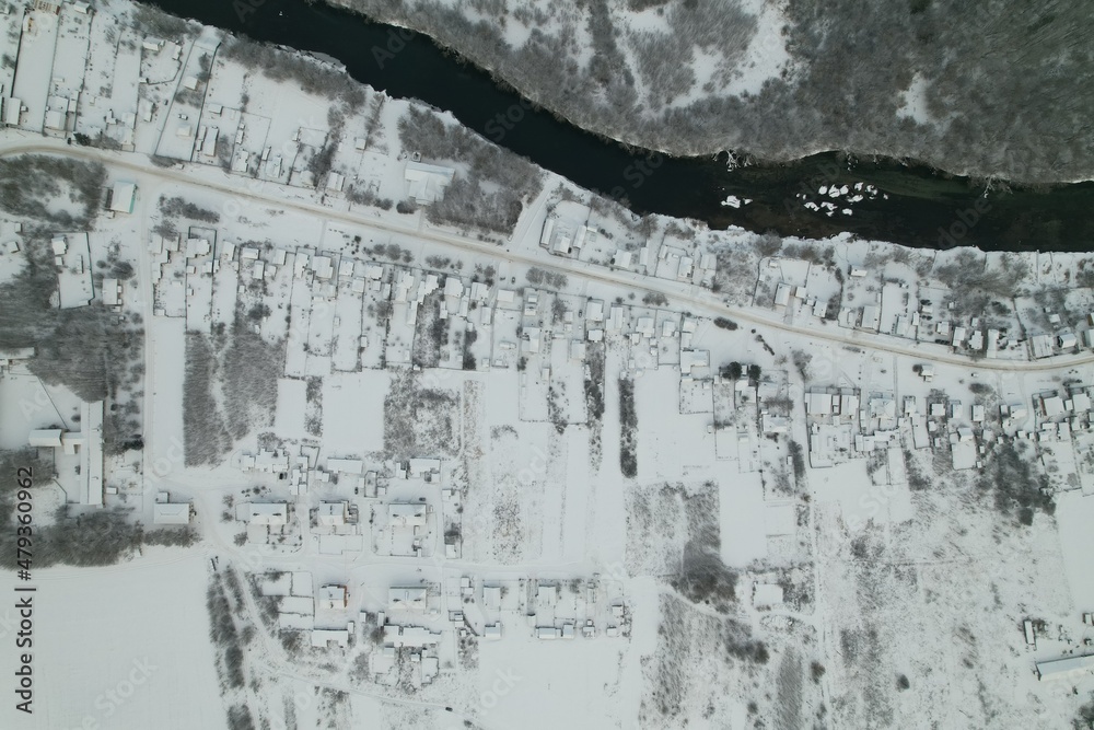 Village in winter with drone